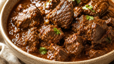 Homemade beef curry with tender beef chunks in rich reddish-brown curry gravy.
