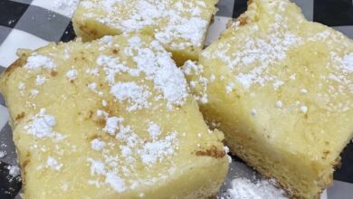 Gooey Butter Cake with powdered sugar, cut into squares