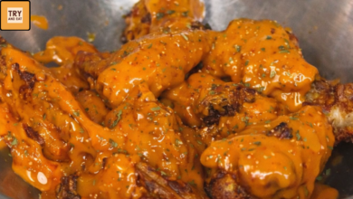 Crispy air fryer Cajun buffalo chicken wings coated in spicy buffalo sauce
