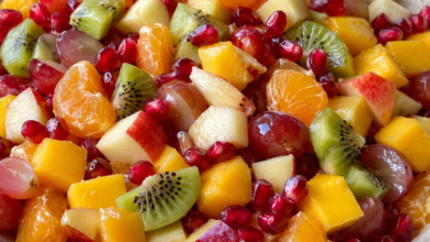 Easy winter fruit salad with mandarin oranges, mango, kiwi, apples, red grapes, and pomegranate arils