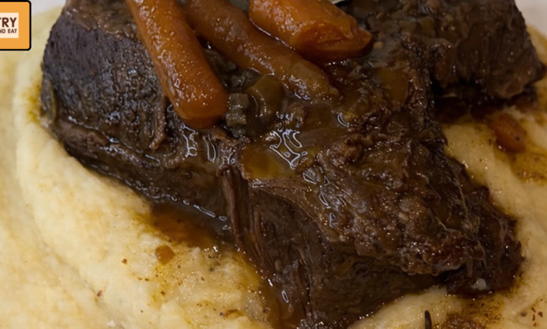 fall apart beef short ribs served over creamy garlic butter mashed potatoes with carrots and rich braising gravy