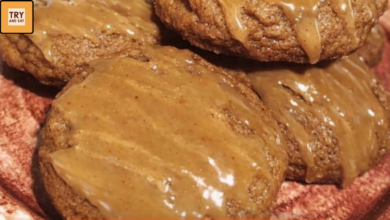 Soft pumpkin spice cookies topped with homemade caramel sauce drizzle on a plate