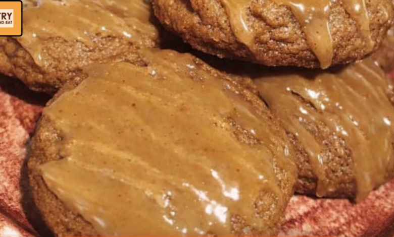 Soft pumpkin spice cookies topped with homemade caramel sauce drizzle on a plate