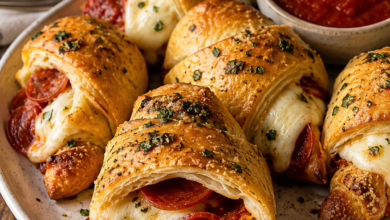 Golden pepperoni pizza crescent rolls filled with melted mozzarella and served with marinara dipping sauce
