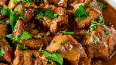 Tender Crockpot beef tips coated in rich homemade brown gravy with onions and fresh parsley.