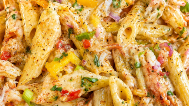 Creamy Cajun crab pasta with penne, lump crab meat, colorful bell peppers, and Parmesan cream sauce.