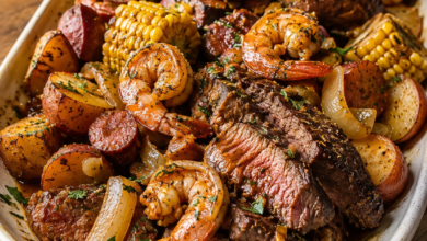 Steak and shrimp boil with sausage, corn, red potatoes and Cajun garlic butter