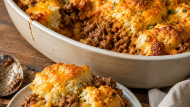 Cheesy Sloppy Joe biscuit casserole with saucy ground beef, golden biscuits, and melted cheddar cheese.