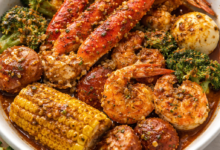 Cajun seafood boil bowl with shrimp, crab legs, corn, potatoes, and garlic butter sauce