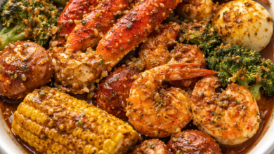 Cajun seafood boil bowl with shrimp, crab legs, corn, potatoes, and garlic butter sauce
