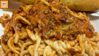 Cheesy baked spaghetti casserole with ground beef and creamy sauce