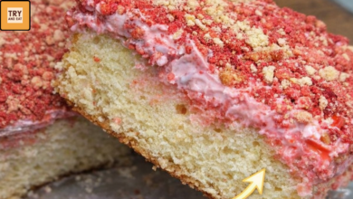 slice of strawberry crunch cake showing soft layers and cream center