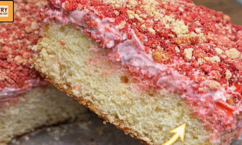 slice of strawberry crunch cake showing soft layers and cream center
