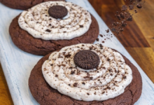 Healthy Crumbl style Oreo protein cookies with creamy frosting and Oreo crumble topping.