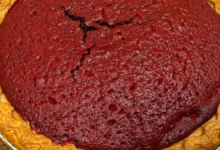 Slice of layered sweet potato pie with red velvet cake top