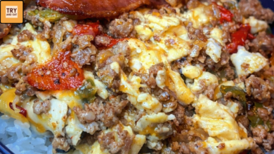 loaded breakfast bowl with rice scrambled eggs bacon and ground beef