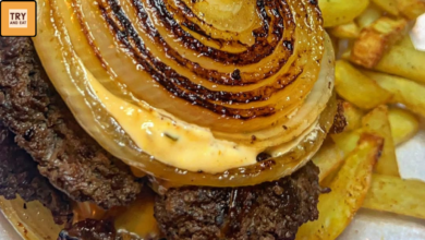 Oklahoma onion smash burger stack with melted cheese and grilled onion rings