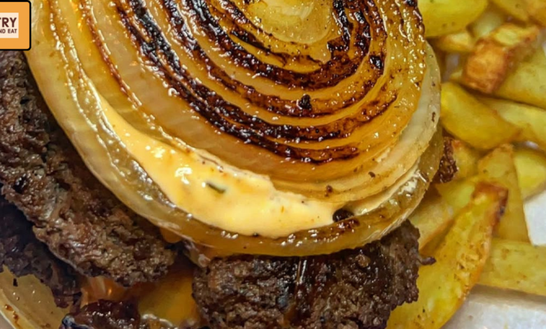 Oklahoma onion smash burger stack with melted cheese and grilled onion rings