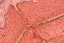 Homemade strawberry cake with creamy cheesecake frosting and dense crumb