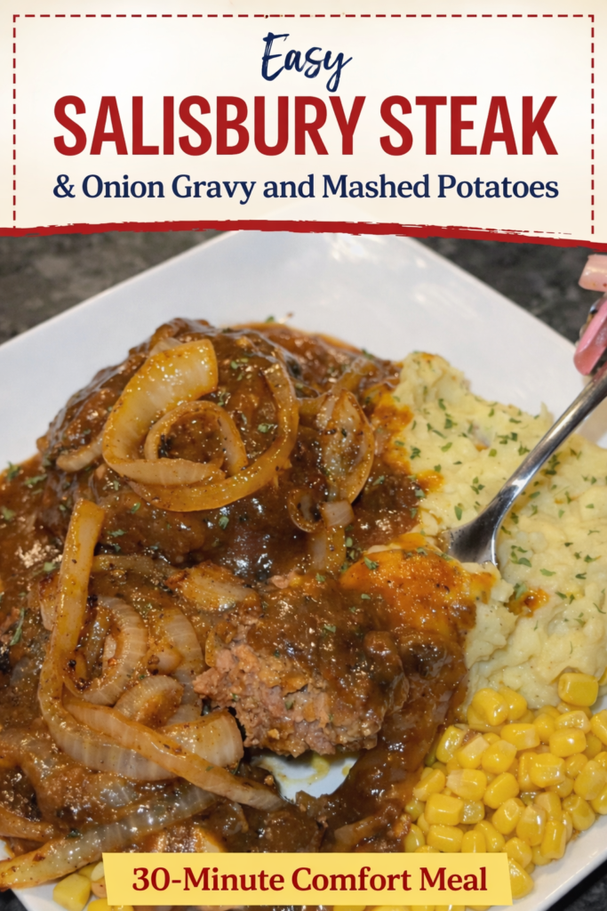 Salisbury steak with onion gravy served over creamy mashed potatoes on a white plate