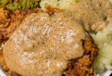 Southern country fried steak with homemade white gravy served in a skillet