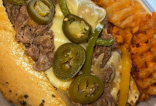 Spicy Philly cheesesteak sandwich with melted cheese jalapenos and seasoned waffle fries