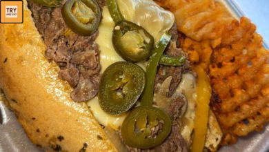 Spicy Philly cheesesteak sandwich with melted cheese jalapenos and seasoned waffle fries