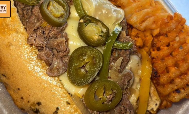 Spicy Philly cheesesteak sandwich with melted cheese jalapenos and seasoned waffle fries
