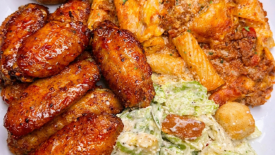 Sticky honey garlic chicken wings served with cheesy baked ziti, garlic bread, and creamy salad