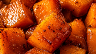 Close-up of brown sugar glazed sweet potato cubes caramelized in a buttery cinnamon glaze.