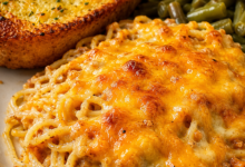 Cheesy baked spaghetti casserole topped with golden melted cheese served with Texas toast garlic bread and Southern green beans.
