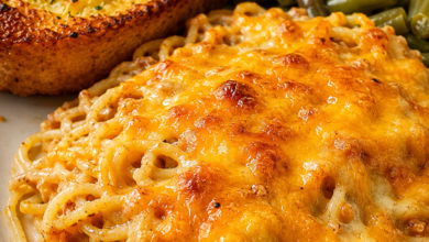 Cheesy baked spaghetti casserole topped with golden melted cheese served with Texas toast garlic bread and Southern green beans.