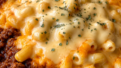 Creamy chili mac and cheese topped with melted cheddar cheese and parsley served with Southern cornbread.