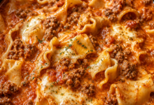 Creamy crockpot lasagna soup with ground beef, mozzarella cheese, tomato broth, and lasagna noodles in a slow cooker.