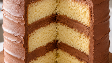 Three-layer vanilla cake with chocolate buttercream frosting and rustic swirl finish.